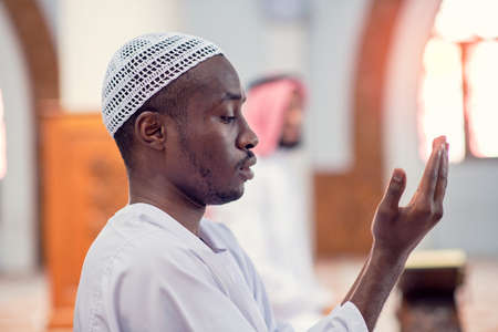 Religious black muslim man praying inside the mosqueの写真素材