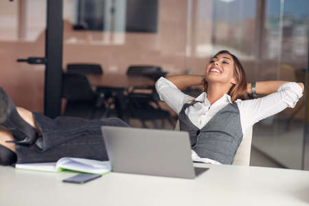 Modern business woman in the office working at computerの写真素材