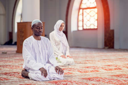 African Muslim Couple Praying inside of beutiful mosqueの写真素材