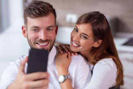 Happy Couple Taking Selfie In Mall Or Officeの写真素材