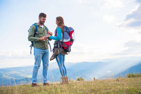 Young couple taking a break on a hike.の写真素材