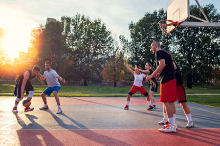 Group Of Young Friends Playing Basketball Matchの写真素材