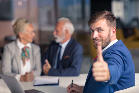 Positive aged couple consulting with insurance agentの写真素材