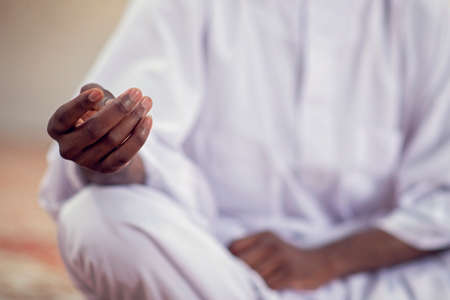 Religious black muslim man praying inside the mosqueの写真素材
