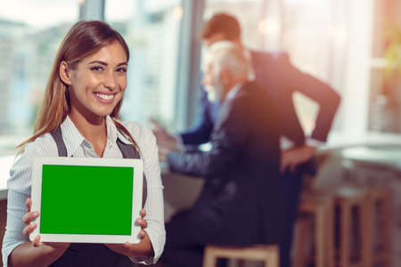 Business woman holding digital tablet. Young smiling.の写真素材