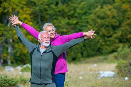 Happy senior couple smiling outdoors in nature. Grandparents, autumn.の写真素材