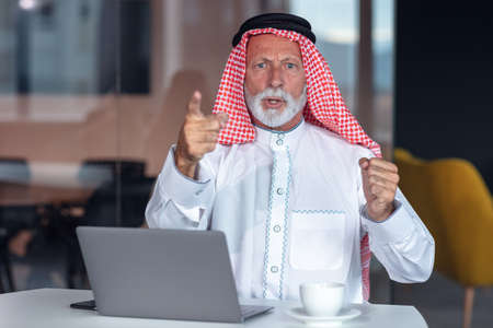 Arab businessman points a warning finger at the camera.の写真素材
