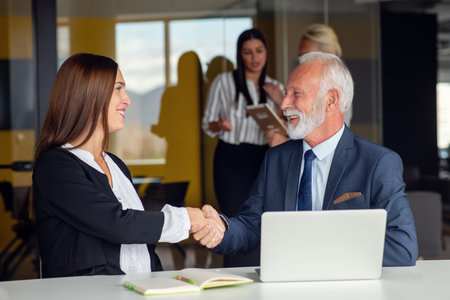 Mature businessman leader mentor talking to diverse colleagues team listening to caucasian ceo.の写真素材