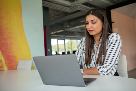 Hipster Girl use Laptop huge Loft Studio.Student Researching Process Work.Young Business Woman Working Creative Startup modern Office.の写真素材