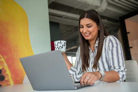 Hipster Girl use Laptop huge Loft Studio.Student Researching Process Work.Young Business Woman Working Creative Startup modern Office.の写真素材