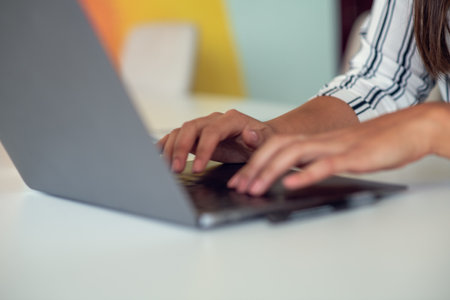 Woman working at home office hand on keyboard close upの写真素材