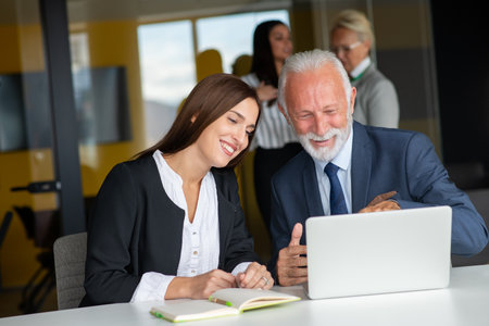 Mature businessman leader mentor talking to diverse colleagues team listening to caucasian ceo.の写真素材