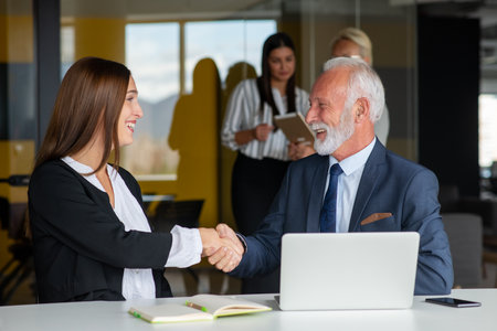 Mature businessman leader mentor talking to diverse colleagues team listening to caucasian ceo.の写真素材