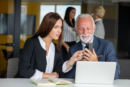 Mature businessman leader mentor talking to diverse colleagues team listening to caucasian ceo.の写真素材