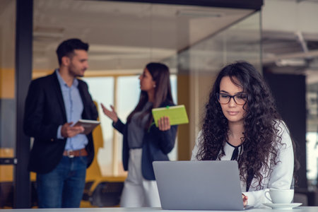 Confident attractive young business woman with tablet in hands in modern office start up officeの写真素材