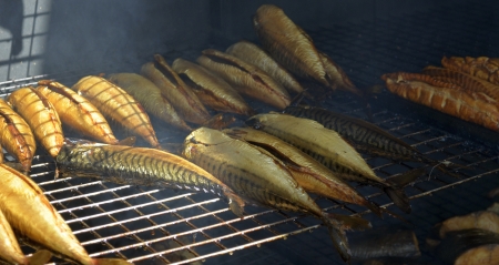 Smoked fish during the process in smokehouseの写真素材