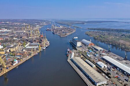 SZCZECIN, POLAND - 08 APRIL 2019 - Aerial view on Szczecin city, area Szczecin Cargo Port and Odra Zachodnia river bank with Port Cranes.のeditorial素材