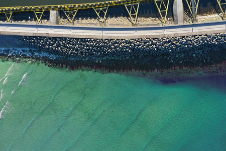 Aerial top down view on sea breakwaters and ship port entrance