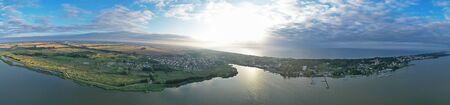 Drone Aerial 360 Degree Wide Panoramic View on Touristic City Located on Spit between Sea and Lake.