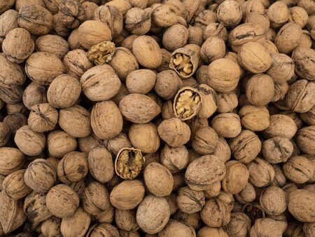Walnut background, scattered pile of walnuts