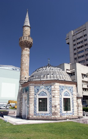 Izmir, Turkey - April 13, 2005: Tourists  walk near ancient Camii mosque on Konak square.のeditorial素材