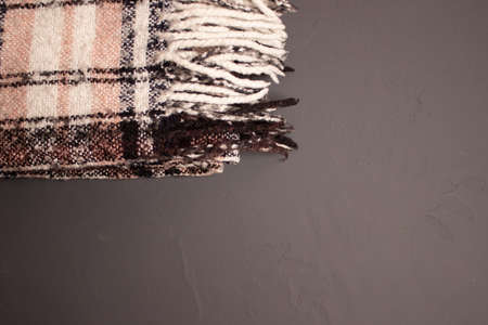 warm bright checkered scarf on gray background.