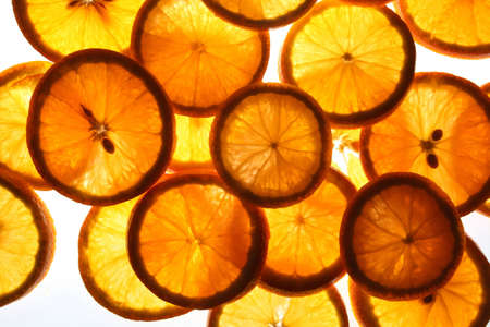 Cut segments of an orange on a white background.の写真素材
