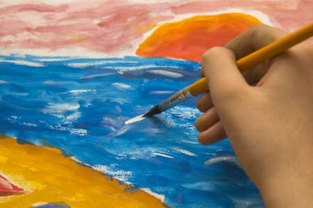 Kid painting with brushの写真素材