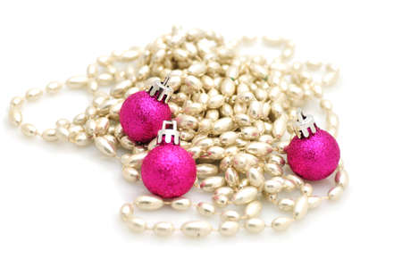 Pink glitter Christmas decorations and silver beads isolated on white backgroundの写真素材