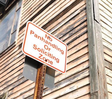 no panhandling or soliciting zone sign near wooden buildingの写真素材