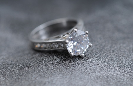 diamond ring on elegant gray leather backgroundの写真素材