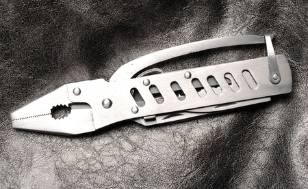 Multi-purpose tool on gray textured background