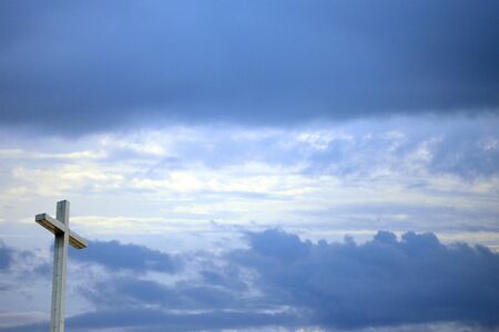 Christian background with cross sun shining through and skyの写真素材