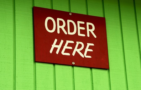 order here sign on green wallの写真素材