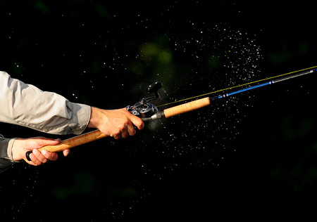 fishing outdoors for recreation with water sprayの写真素材