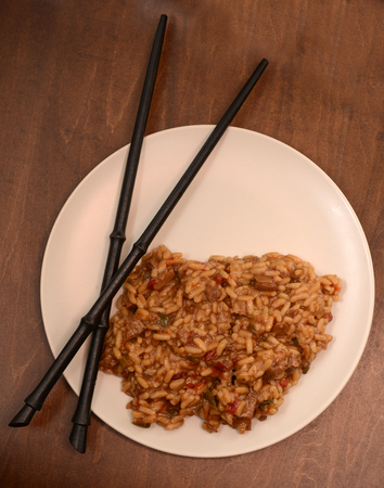 rice dish with chopsticks on wood tableの写真素材