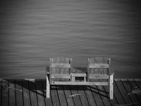 Empty bench overlooking the water in a tranquil scene