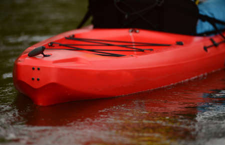 red kayak in a river or lake for an outdoor activity