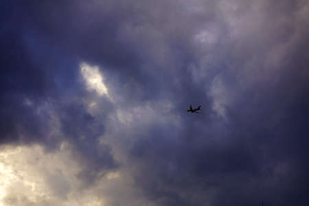 Dark cloud with aircraftの写真素材