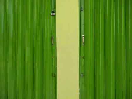 green color wall and harmonica doorの写真素材
