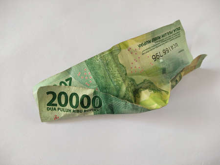 Indonesian paper money on white background.IDR cash currency,old, folded banknotes, business concept