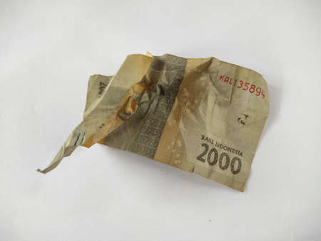 Indonesian paper money on white background.IDR cash currency,old, folded banknotes, business concept