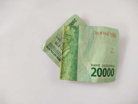 Indonesian paper money on white background.IDR cash currency,old, folded banknotes, business concept