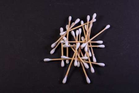 Cutton bud or cotton swab shot on a black background.の写真素材