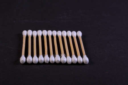 Cutton bud or cotton swab shot on a black background.の写真素材