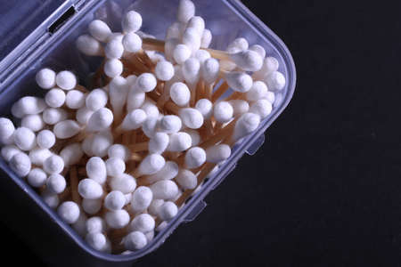 Cutton bud or cotton swab shot on a black background.の写真素材