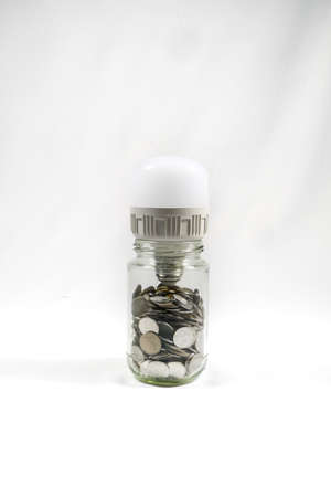 Financial concept, A malaysia ringgit coin in transparent glass bottle isolated white backgroundの写真素材