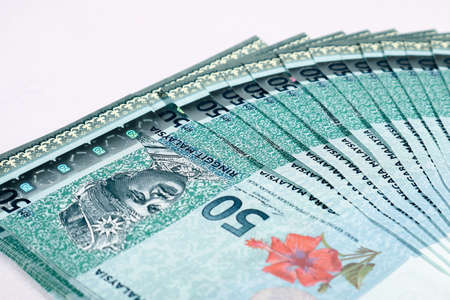 Malaysia Currency (MYR): Stack of Ringgit Malaysia bank note. There is a fifty ringgit malaysia...