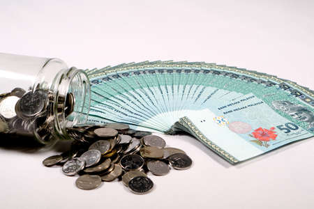 Financial concept, A malaysia ringgit coin in transparent glass bottle isolated white backgroundの写真素材