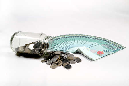 Financial concept, A malaysia ringgit coin in transparent glass bottle isolated white background